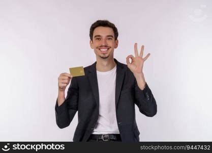 Portrait of Young smiling handsome businessman showing credit card and ok sign hand isolated over white background. Online shopping, ecommerce, internet banking, spending money concept.