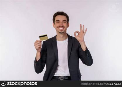 Portrait of Young smiling handsome businessman showing credit card and ok sign hand isolated over white background. Online shopping, ecommerce, internet banking, spending money concept.