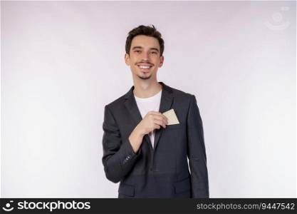 Portrait of Young smiling handsome businessman showing credit card isolated over white background. Online shopping, ecommerce, internet banking, spending money concept.