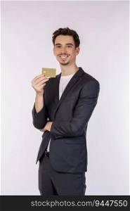 Portrait of Young smiling handsome businessman showing credit card isolated over white background. Online shopping, ecommerce, internet banking, spending money concept.