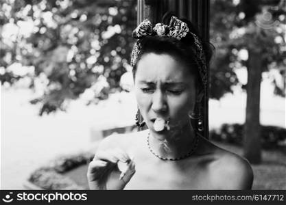 Portrait of young smoking woman coughing tobacco smoke