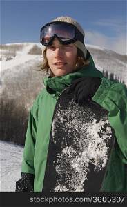 Portrait of young snowboarder smiling