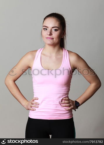 Portrait of young sporty woman fit fitness girl on gray. Sport training. Studio shot.