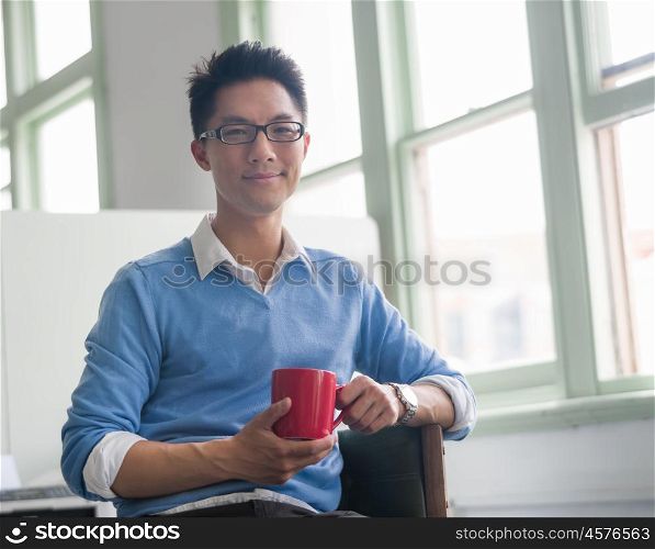 Portrait of young successful businessman in office. Portrait of young businessman