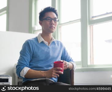 Portrait of young successful businessman in office. Portrait of young businessman