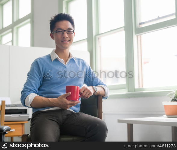 Portrait of young successful businessman in office. Portrait of young businessman