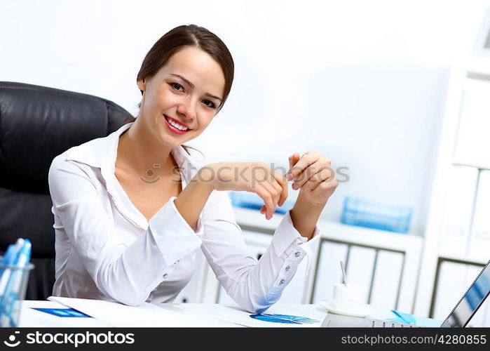 Portrait of young successful businesswoman in the office