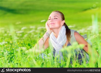Portrait of young traveler girl resting outdoors on fresh green grass field, active lifestyle, summertime tourism, pleasure concept