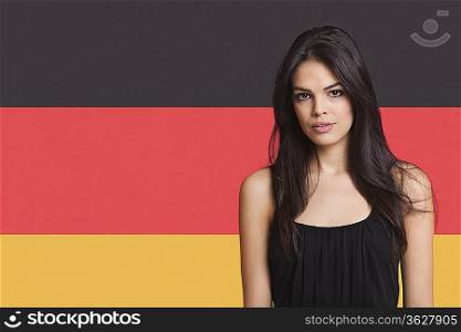 Portrait of young woman against German flag