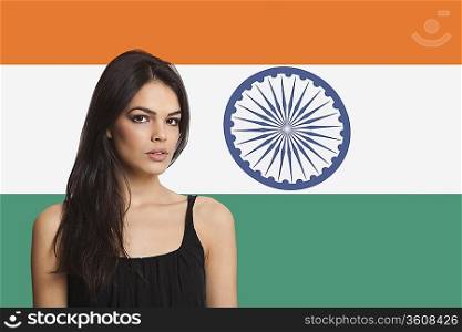 Portrait of young woman against Indian flag