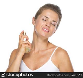 Portrait of young woman applying perfume