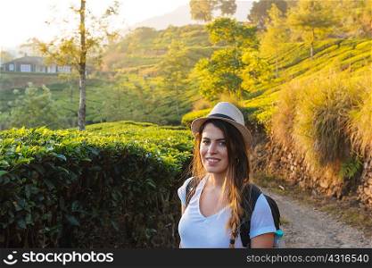 Portrait of young woman at tea plantations near Munnar, Kerala, India