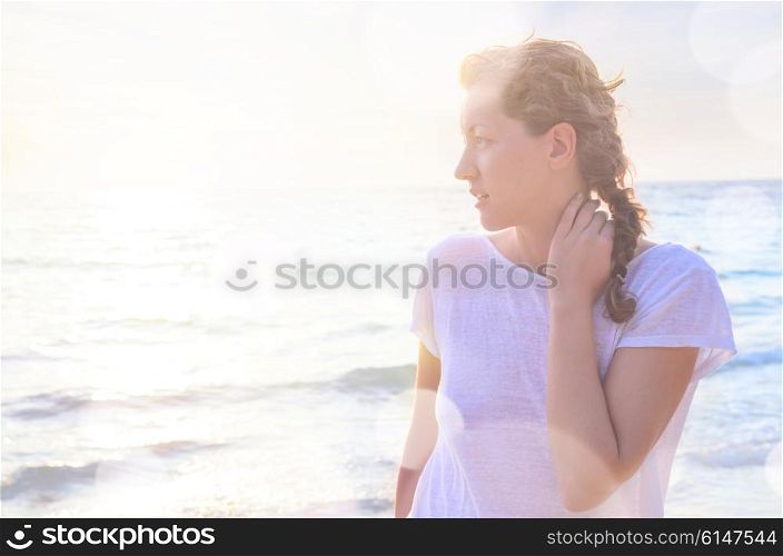 Portrait of young woman at the beach. Closeup portrait of young smiling caucasian woman at the beach