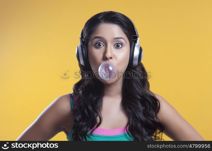 Portrait of young woman blowing a bubble