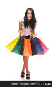 Portrait of young woman carrying shopping bags against white background
