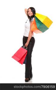 Portrait of young woman carrying shopping bags against white background