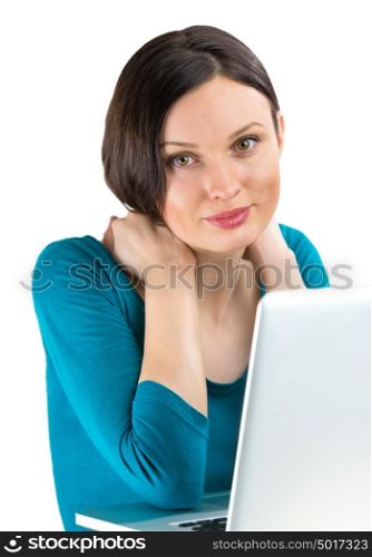 Portrait of young woman dreaming in front of laptop