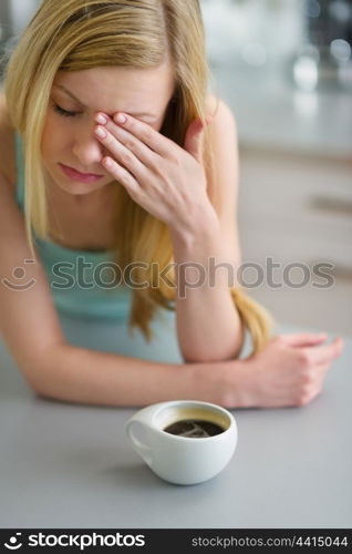 Portrait of young woman drinking coffee in the morning