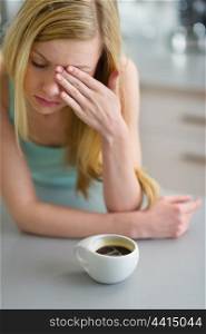 Portrait of young woman drinking coffee in the morning