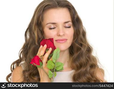 Portrait of young woman enjoying red rose