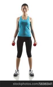 Portrait of young woman exercising with dumbbells isolated over white background