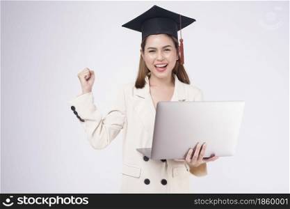 Portrait of young woman graduated over white background