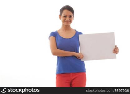 Portrait of young woman holding a white board