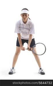 Portrait of young woman holding tennis racket isolated over white background