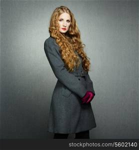 Portrait of young woman in autumn coat. Fashion photo