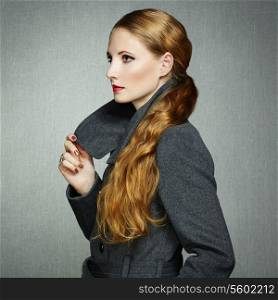 Portrait of young woman in autumn coat. Fashion photo