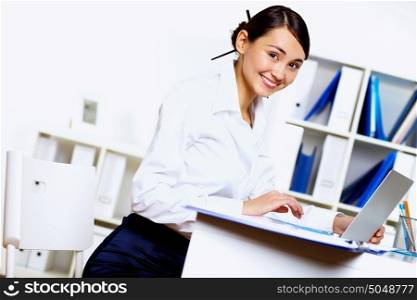 Portrait of young woman in business wear in office