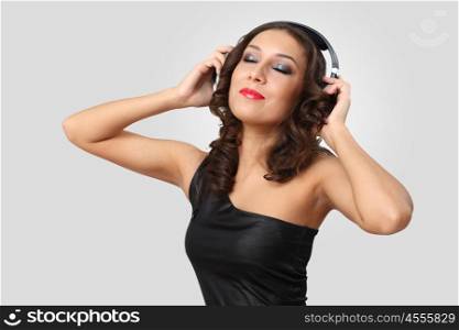Portrait of young woman in evening dress with headphones