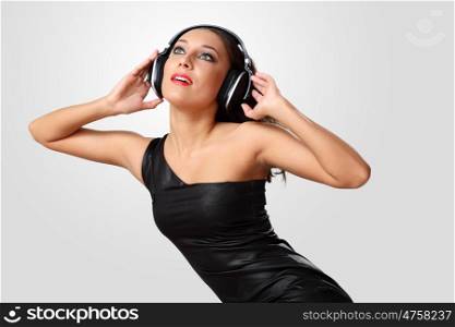 Portrait of young woman in evening dress with headphones