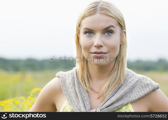 Portrait of young woman in field