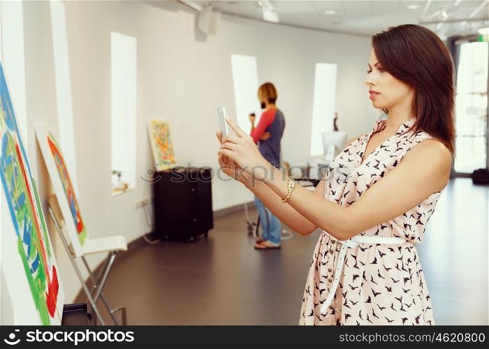 Portrait of young woman in gallery. Portrait of pretty young woman standing in gallery