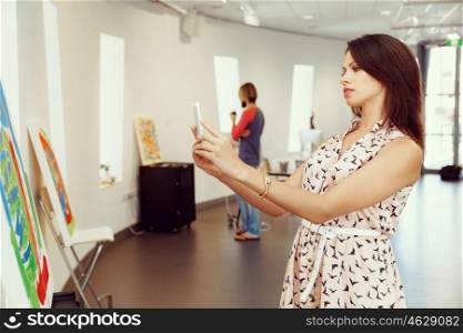 Portrait of young woman in gallery. Portrait of pretty young woman standing in gallery