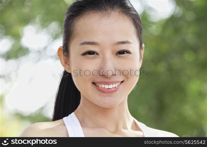 Portrait of Young Woman in Park