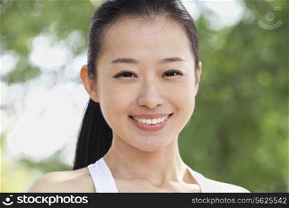 Portrait of Young Woman in Park