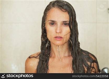 Portrait of young woman in shower