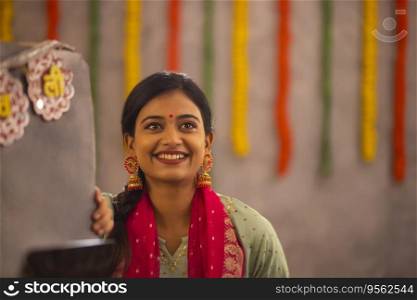 Portrait of young woman in traditional outfit in office during Diwali celebration