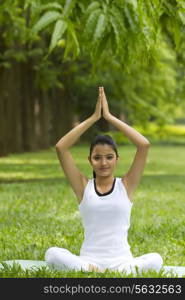 Portrait of young woman in yoga position