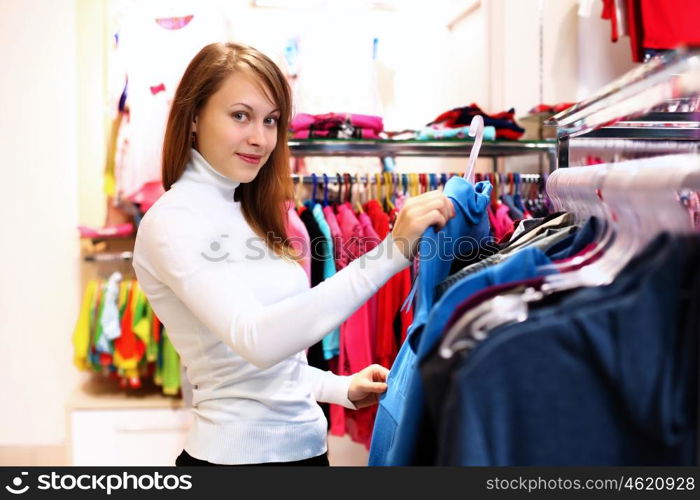 Portrait of young woman inside a store buying clothes