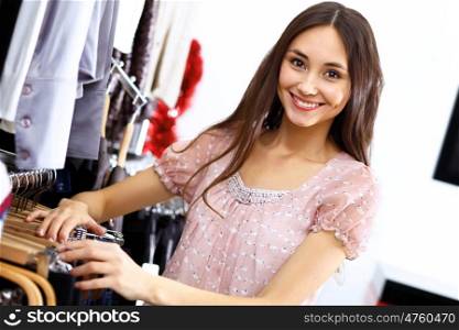 Portrait of young woman inside a store buying clothes