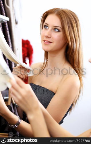 Portrait of young woman inside a store buying clothes