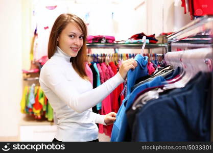 Portrait of young woman inside a store buying clothes