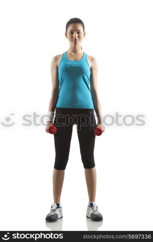 Portrait of young woman lifting dumbbells isolated over white background