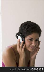 Portrait of young woman listening to music with headphones