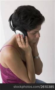 Portrait of young woman listening to music with headphones