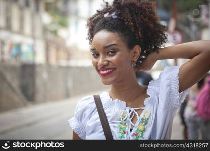 Portrait of young woman, looking at camera, smiling