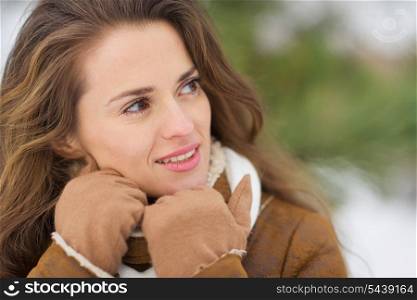 Portrait of young woman looking on copy space in winter park